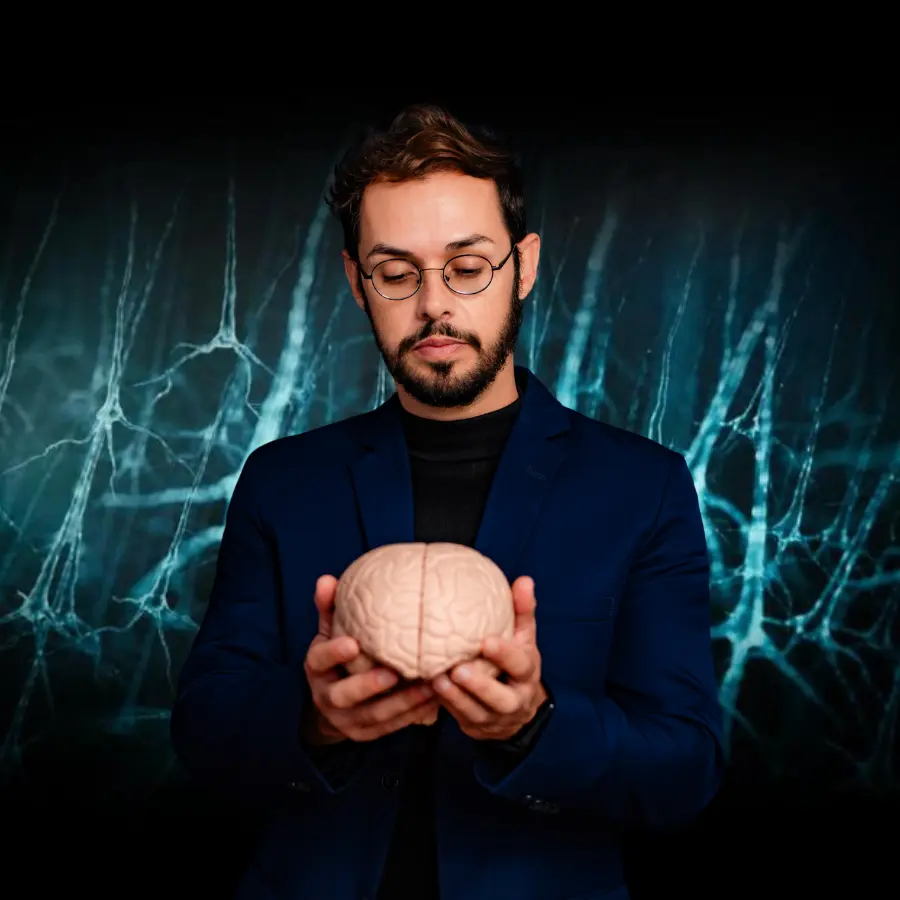 Neurocientista Dr. Allan Felippe analisando o cérebro humano, com fundo de conexões neurais para o curso de neurociência comportamental.